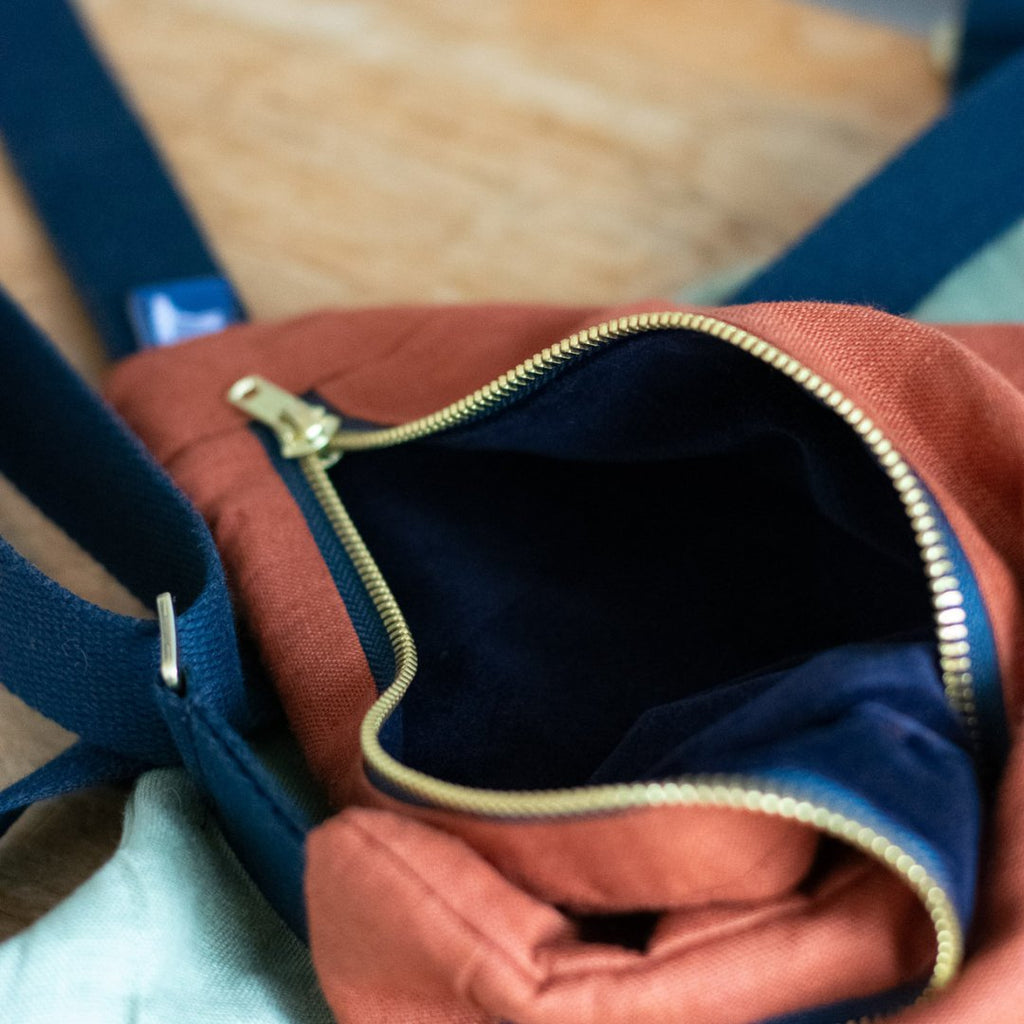 Rust Coloured Linen Cross Body Bag with zip opened showing dark blue velvet lining from Helen Round