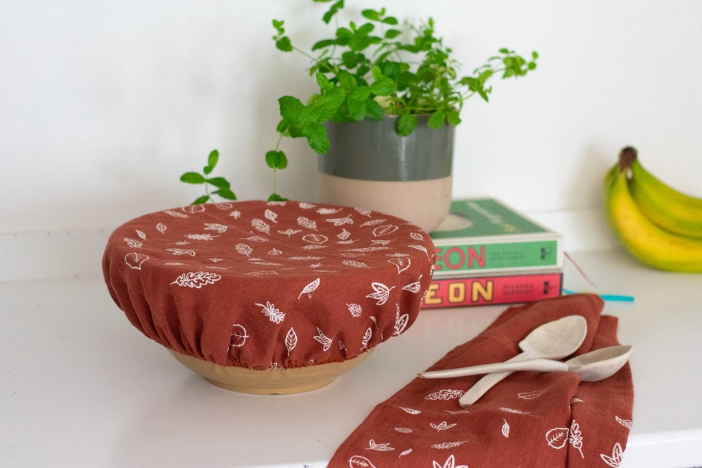 Rust Coloured Linen Leaf Large Bowl Cover from the Leaf Collection by Helen Round pictured with Leaf Tea Towel