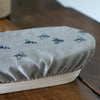 Close up of Oval Linen Banneton/Bowl Cover in Natural Linen from the Honey Bee Collection by Helen ROund