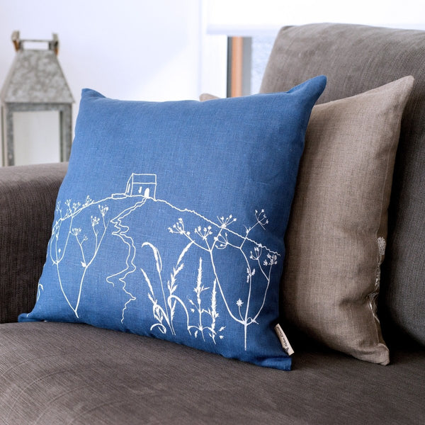 The coastal-inspired Indigo blue linen cushion features a hand printed design in white from The Rame Head Collection by Helen Round.