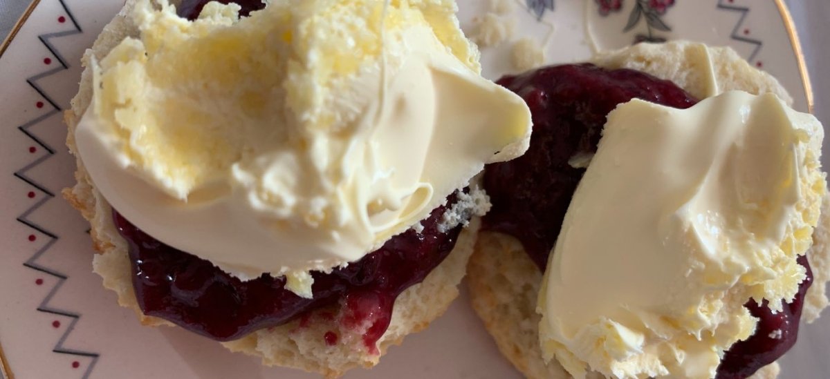 Two Scones with Jam and Cream on a Plate