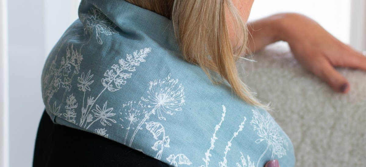Duck Egg Blue Linen Wheat Bag Placed on Shoulders For Natural Heat Therapy from Helen Round