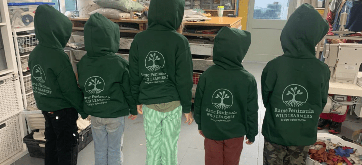 Rame Wild Learners showing off their new green hoodies