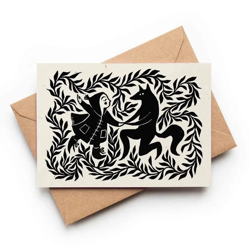 Card with black cut-out design of a woman and a horse on a beige background, with a brown envelope.