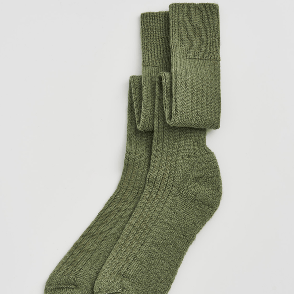 Pair of green socks on a light gray background