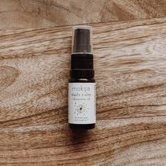 Small spray bottle with a label on a wooden surface