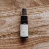 Small spray bottle with a label on a wooden surface
