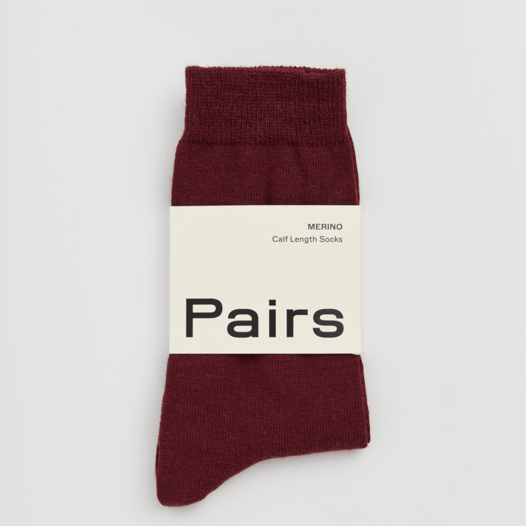 Maroon sock with a white label displaying 'Pairs' on a light gray background