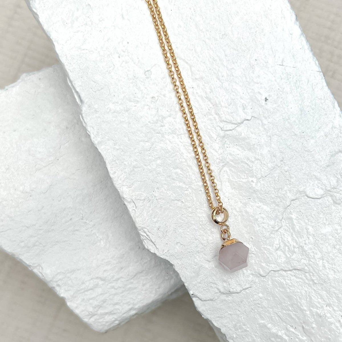 Rose Quartz Nugget Necklace pendant on a textured white surface sold by Helen Round