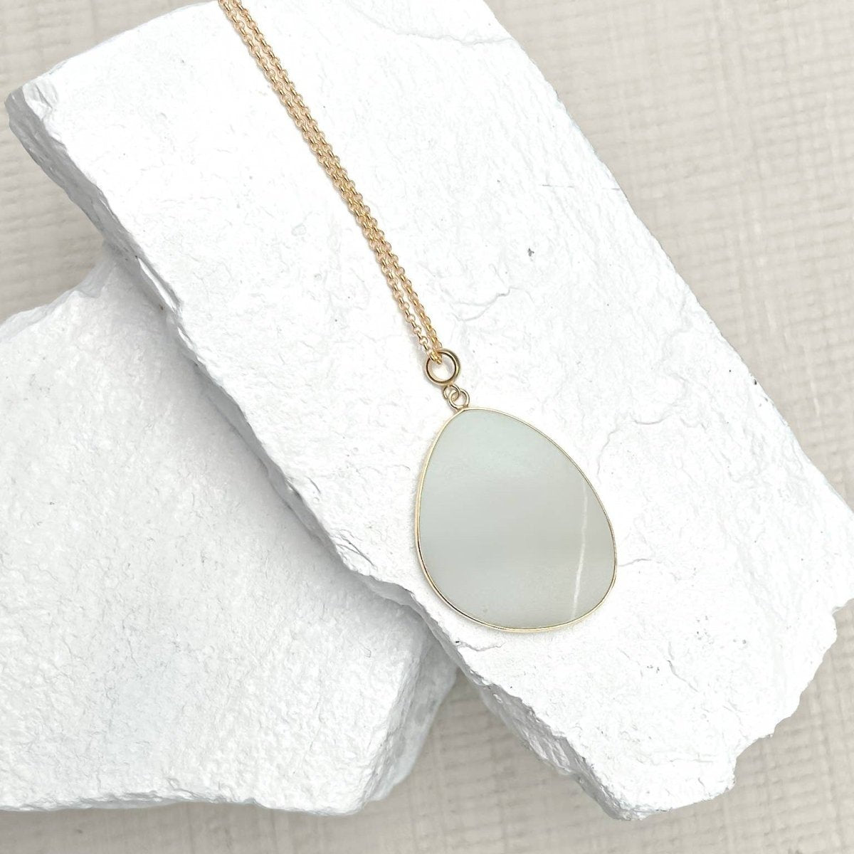 Amazonite Disc Necklace on a white stone surface. Sold by Helen Round