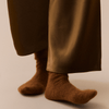 Brown pants and socks on a neutral background