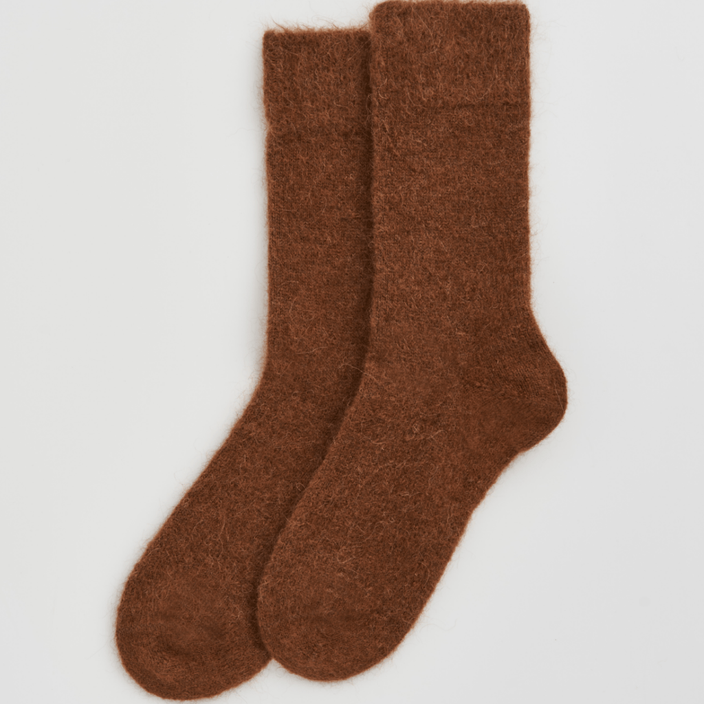 Pair of brown socks on a light gray background
