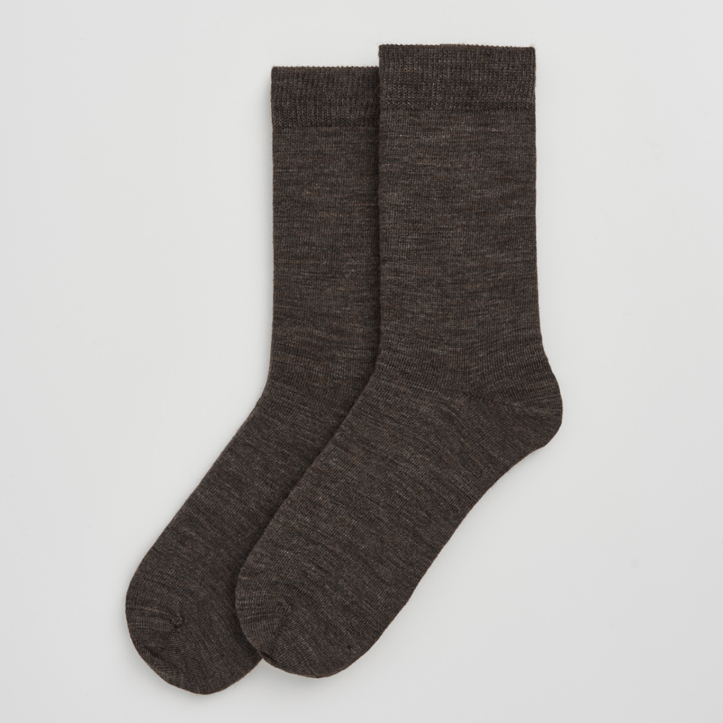 Pair of dark brown socks on a light gray background
