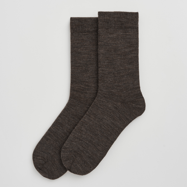 Pair of dark brown socks on a light gray background