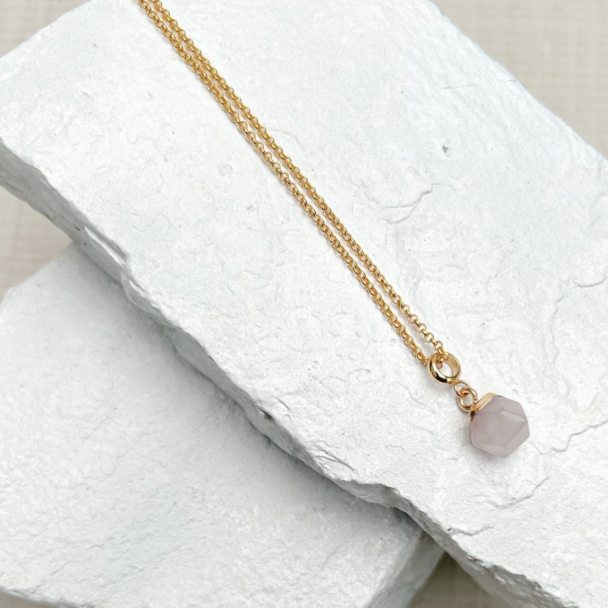 Rose Quartz Nugget Necklace pendant on a textured white surface sold by Helen Round