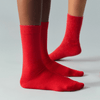 Red socks worn by a person on a gray background