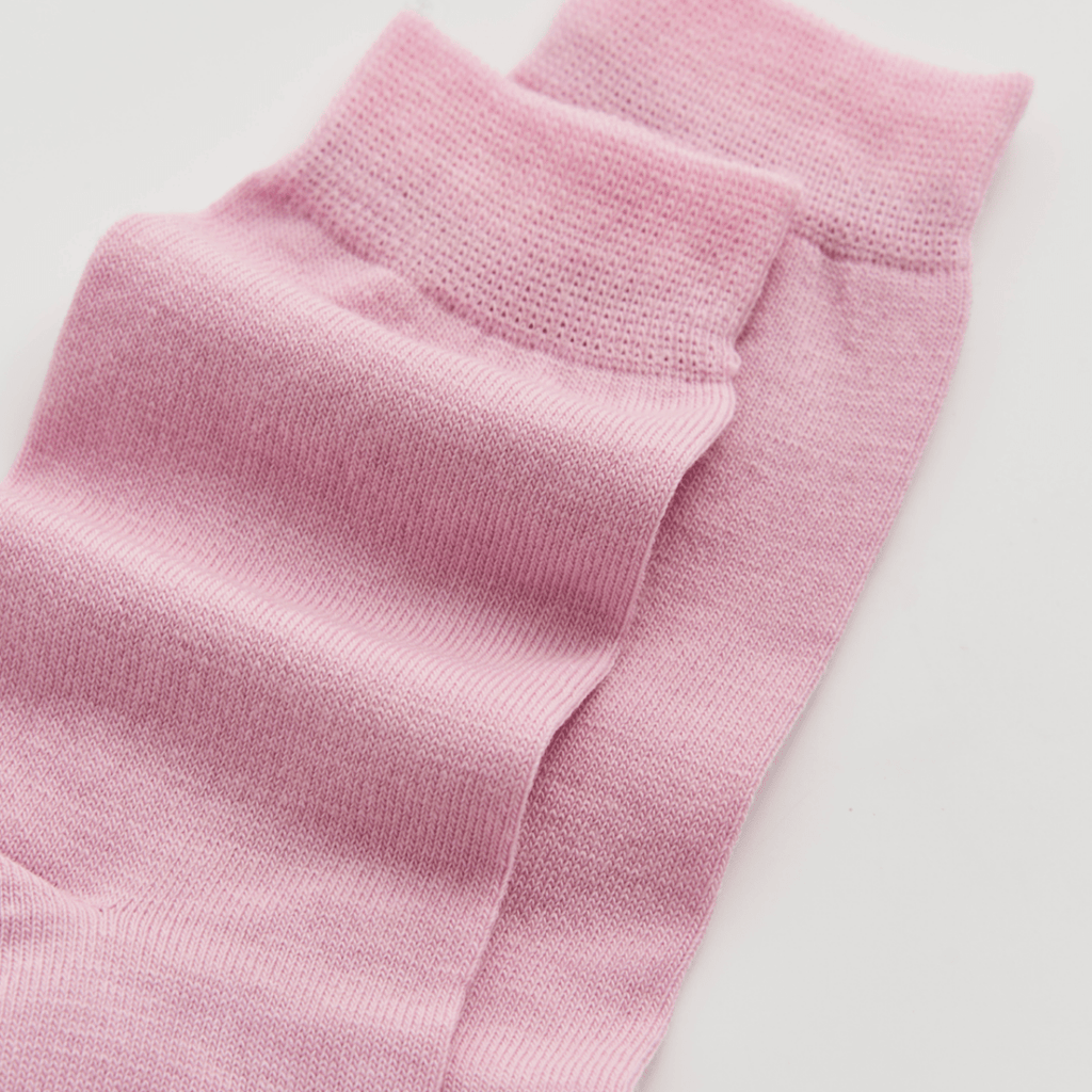 Close-up of pink socks on a light gray background