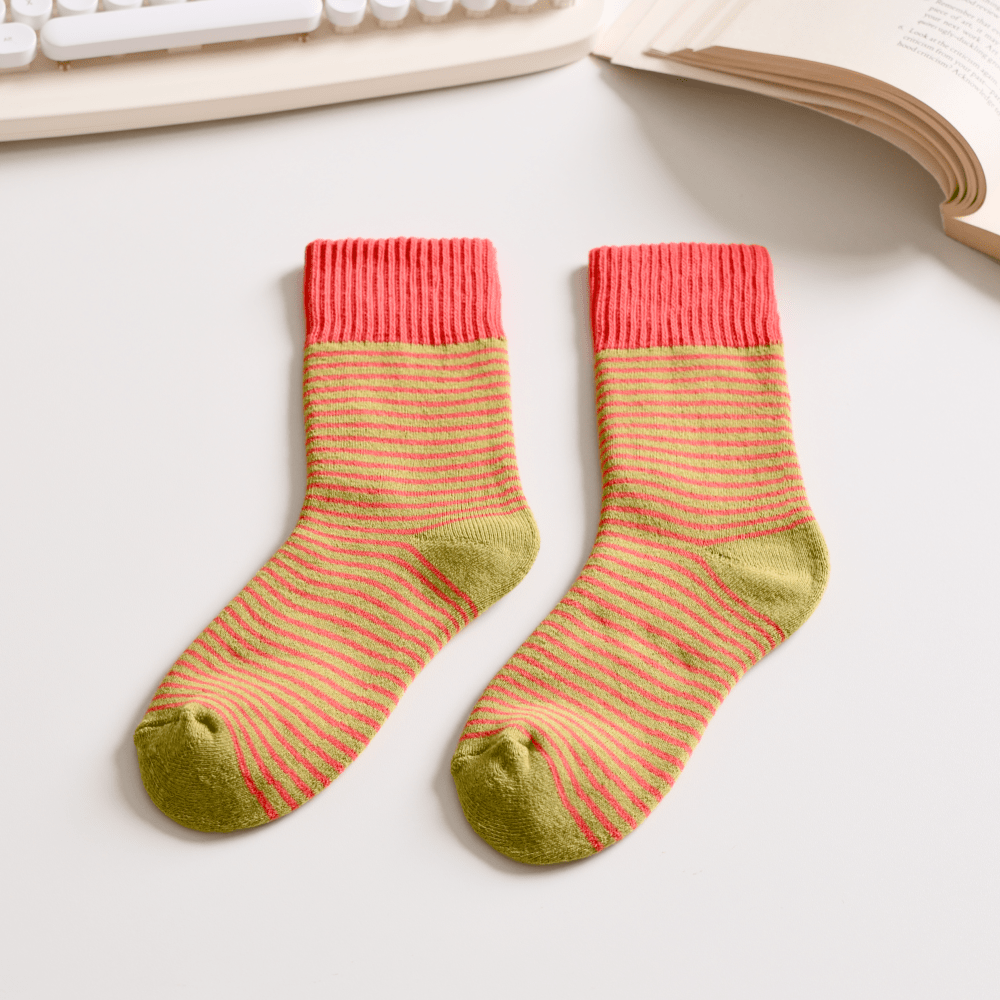 Pair of striped socks on a light surface with a keyboard and book in the background sold by Helen Round