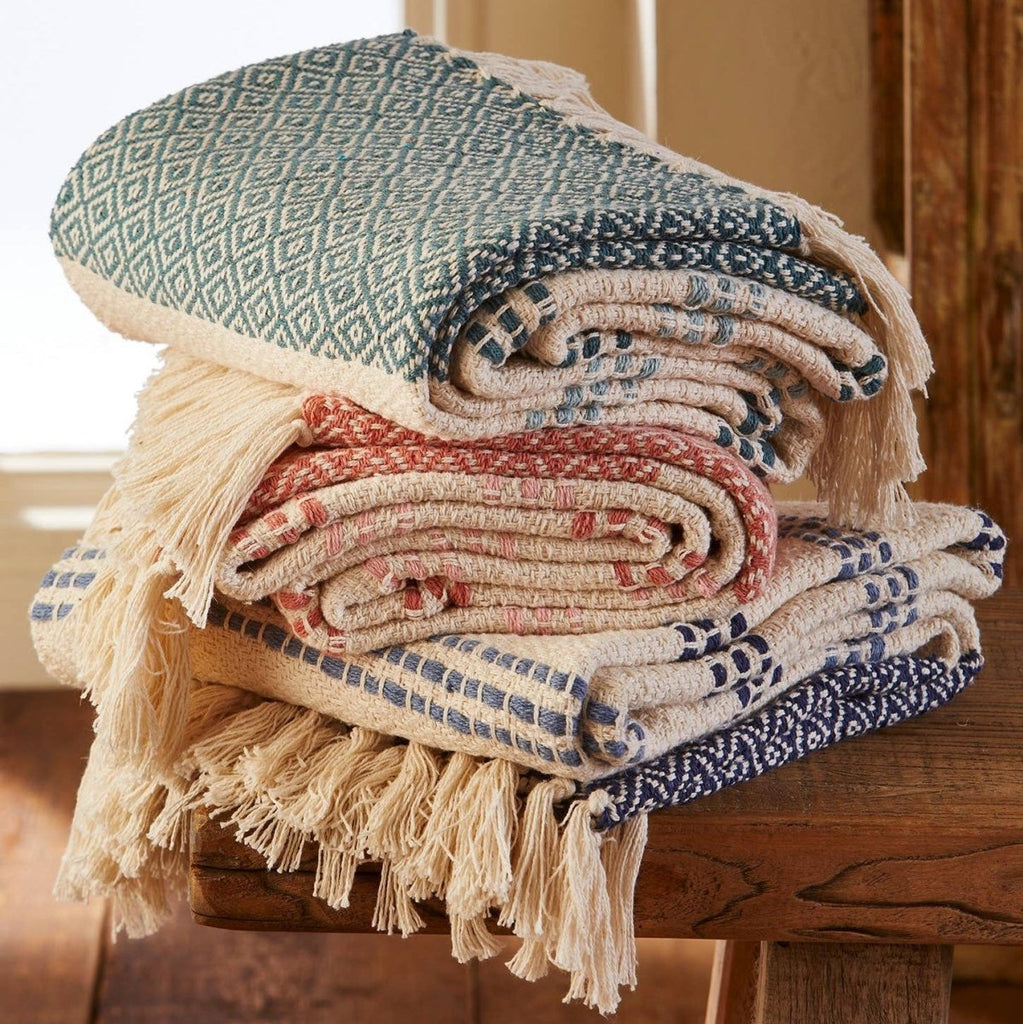 Stack of patterned towels on a wooden stool