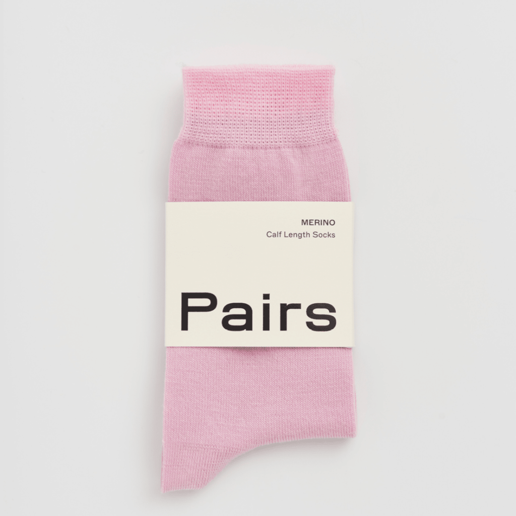 Pink sock with 'Pairs' label on a light gray background
