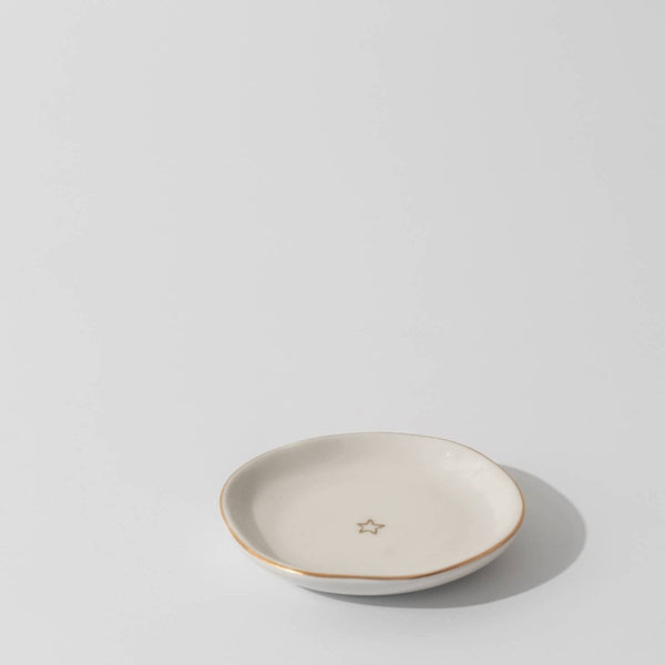 Small ceramic dish with a star design on a light gray background