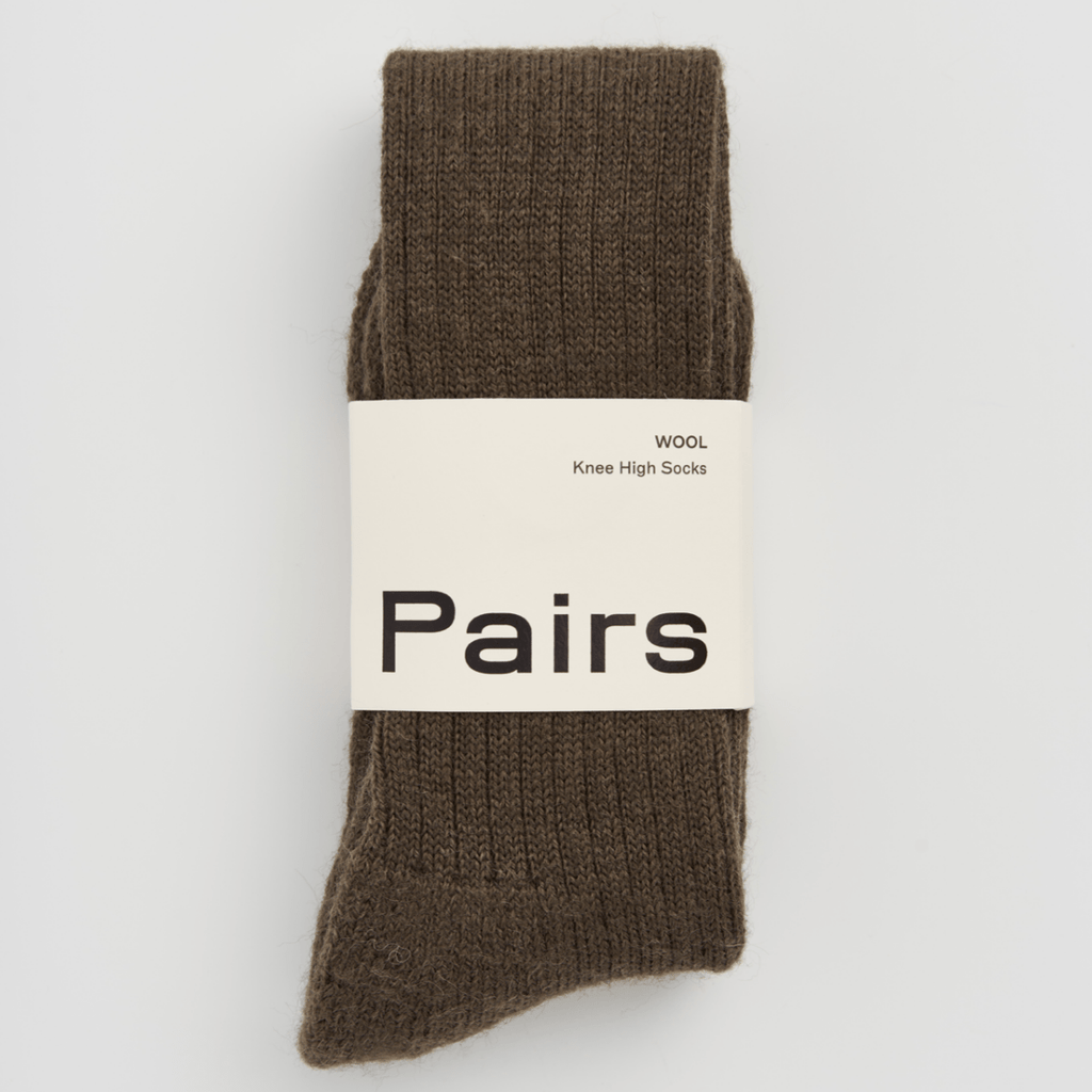 Brown sock with 'Pairs' label on a light gray background