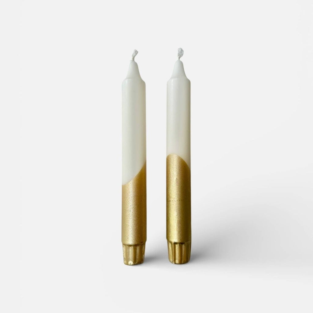Two candles with white tops and gold bottoms on a white background sold by Helen round
