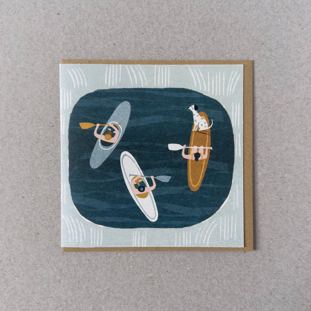 Illustrated card with people in kayaks and a dog on a rock, on a textured gray background, sold by Helen Round