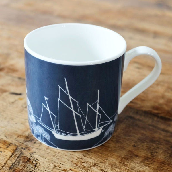Beautiful, fine bone china mug in Navy Blue with a Cornish Lugger Sailing Boat picked out in white. From the Coastal Collection by Helen Round