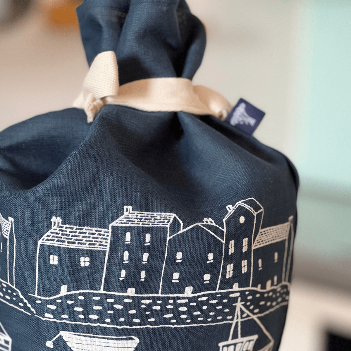 Navy Blue Linen Bread Bag tied with a cottton tie decorated with a screen printed coastal fishing village design from Helen Round.