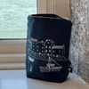 Dark Navy toiletry bag with white illustrations of a coastal scene on a windowsill from Helen Round.