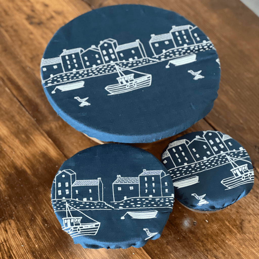 Three blue linen bowl covers with white coastal design on a wooden surface from Helen Round.