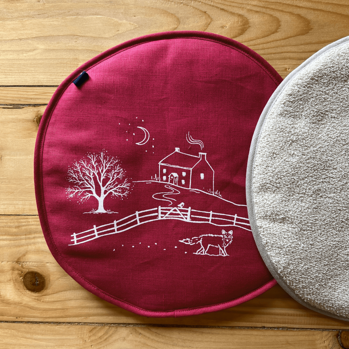 Raspberry linen aga pad from the Winter Fox Collection by Helen Round