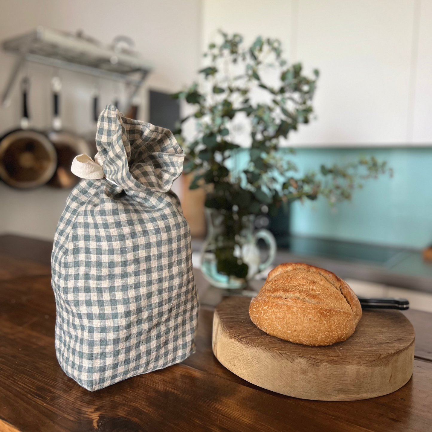 Sea Green Check Linen Bread Bag with sourdough loaf on a bread board from the Check Collection by Helen Round