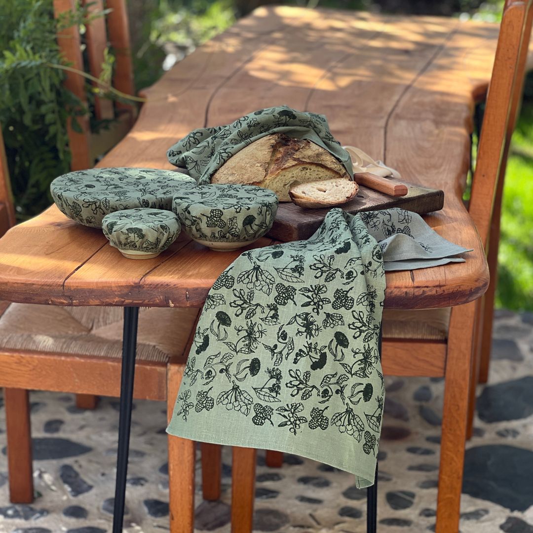 A collection of Helen Rounds Kitchen accessories from the Forager Range, Including a linen bread bag, linen bowl cover set of 3 and a linen tea towel. 
