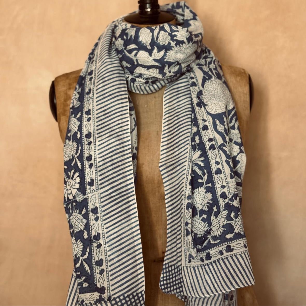 Scarf with floral and striped pattern draped over a mannequin against a beige background from Helen Round