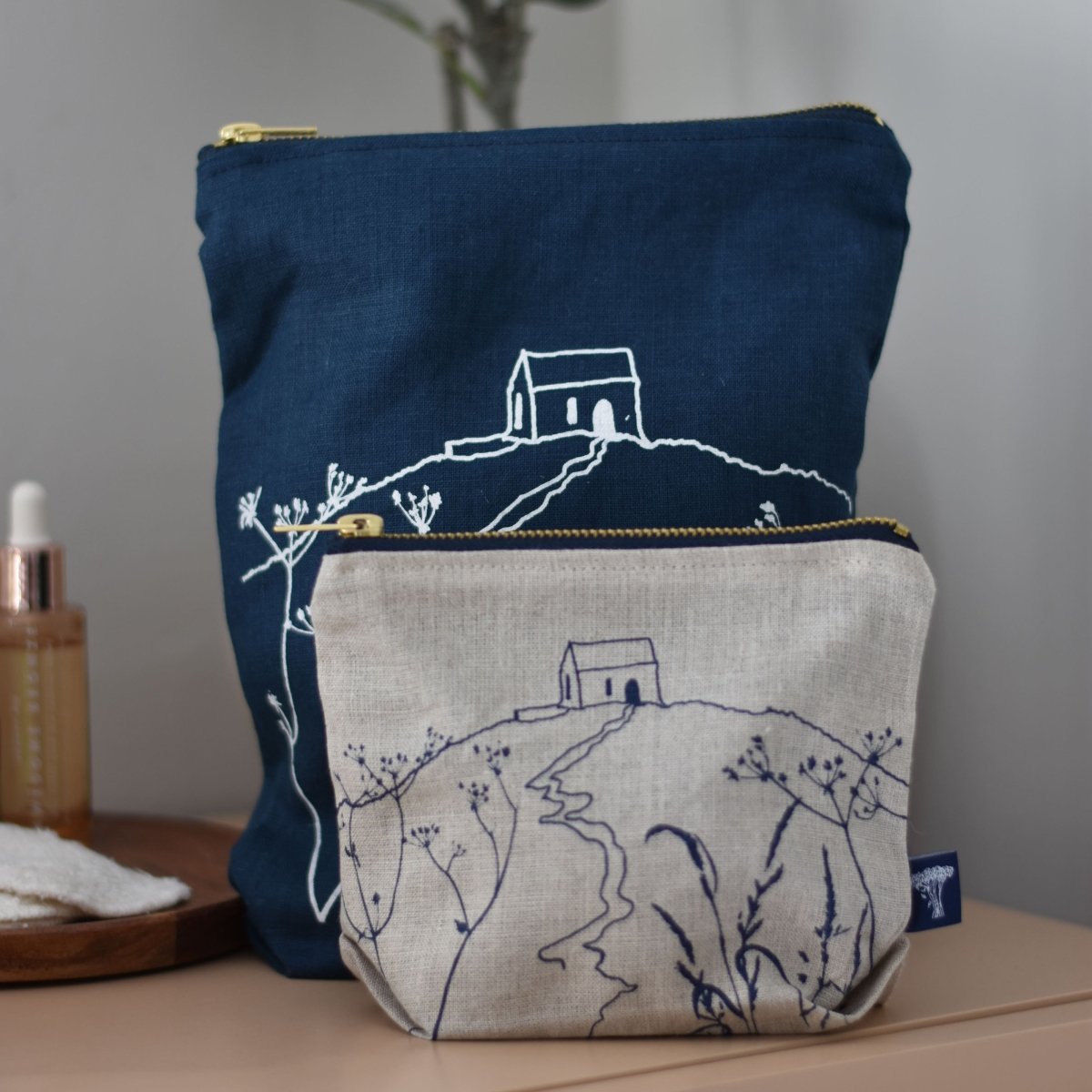 Navy Linen Toiletry Bag and Natural Linen Makeup Bag from the Rame Head Collection by Helen Round