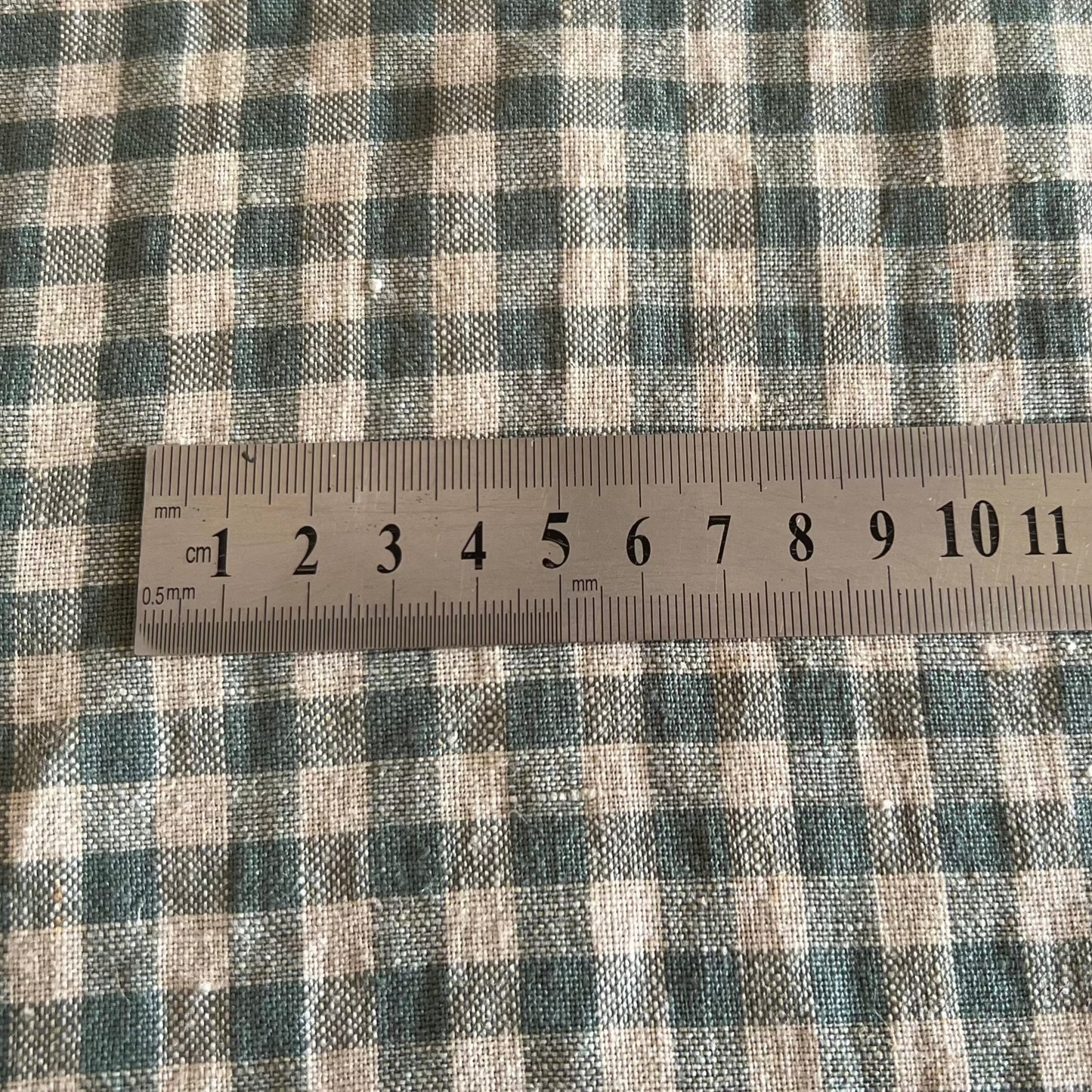 Sea Green Linen Fabric with a centimetre rule illustrating the check size from Helen Round 