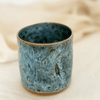 Blue ceramic cup on a beige fabric background sold by Helen Round