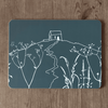 Placemat with white Rame Head design on a slate grey background, placed on a wooden surface from Helen Round