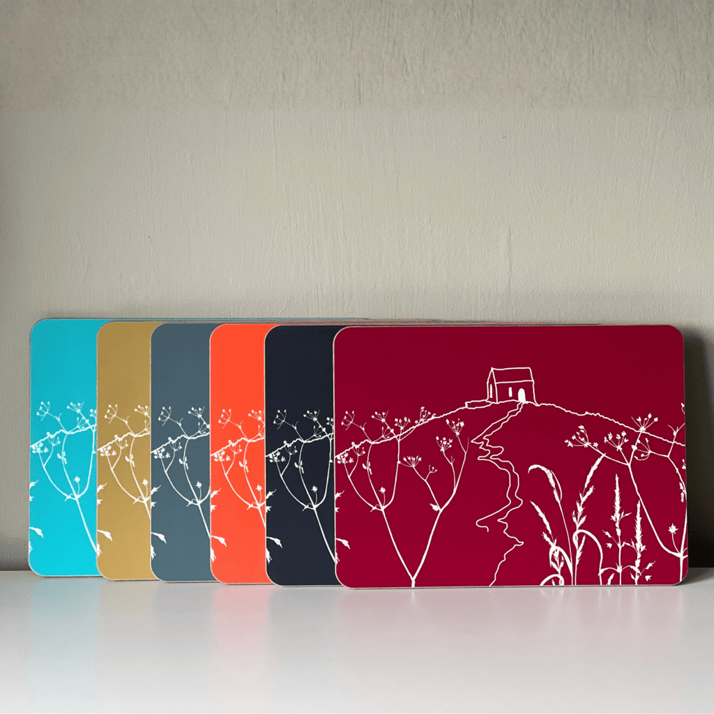 Set of six matt laminate tablemats in different colours with Rame Head design in white from Helen Round