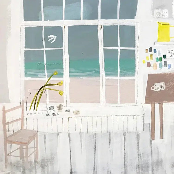 Room with large window showing ocean view, chair, and small table Studio By The Sea Greetings Card Helen Round