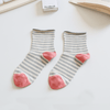 Pair of striped socks with pink toes on a light surface sold by Helen Round