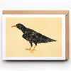 Card with a black bird illustration on a beige background, featuring a brown envelope.