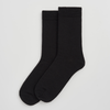 Pair of black merino wool socks on a light grey background