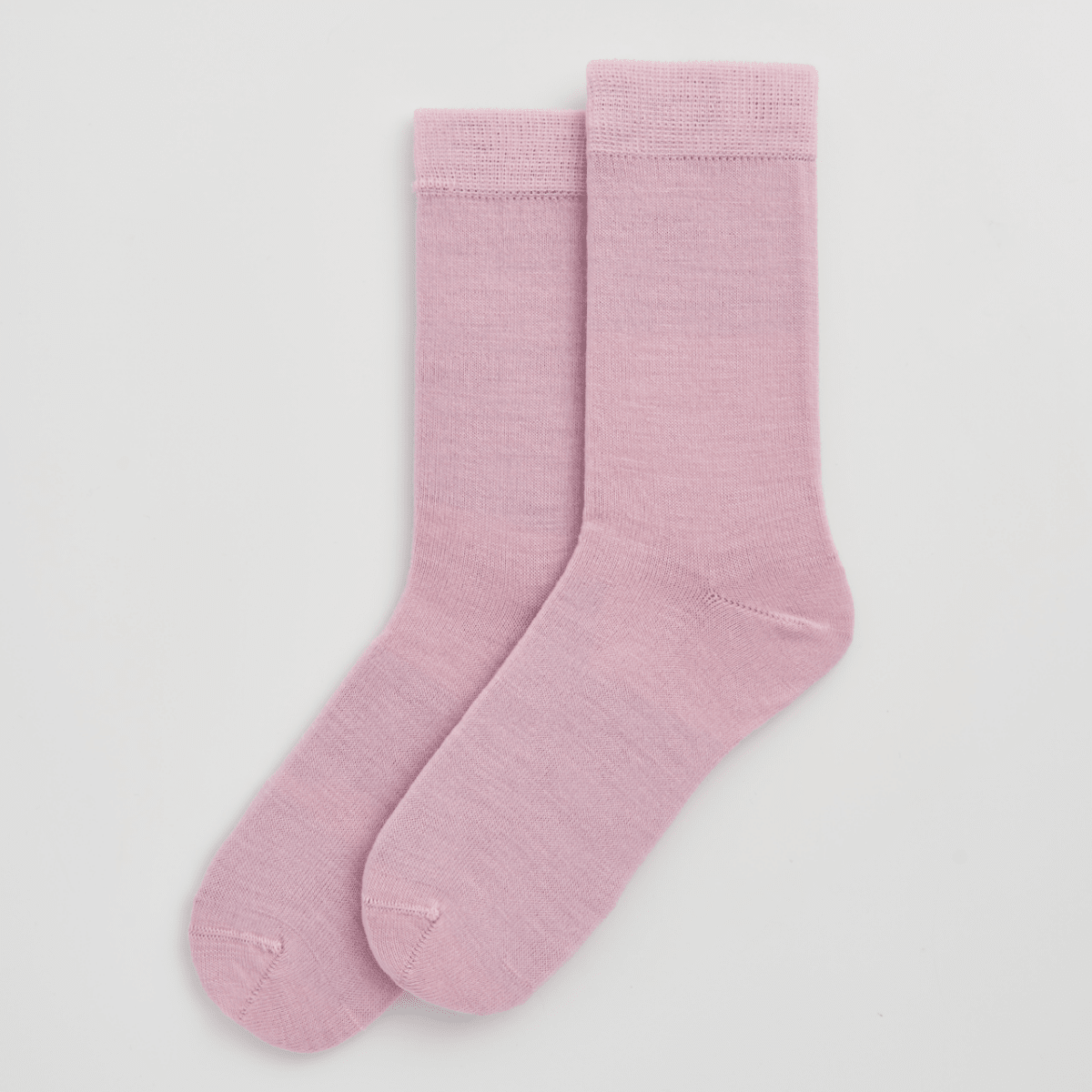 Pair of pink socks on a light gray background sold by Helen Round