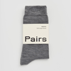 Grey merino wool sock with 'Pairs' label on a light grey background