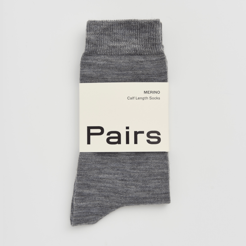 Grey merino wool sock with 'Pairs' label on a light grey background