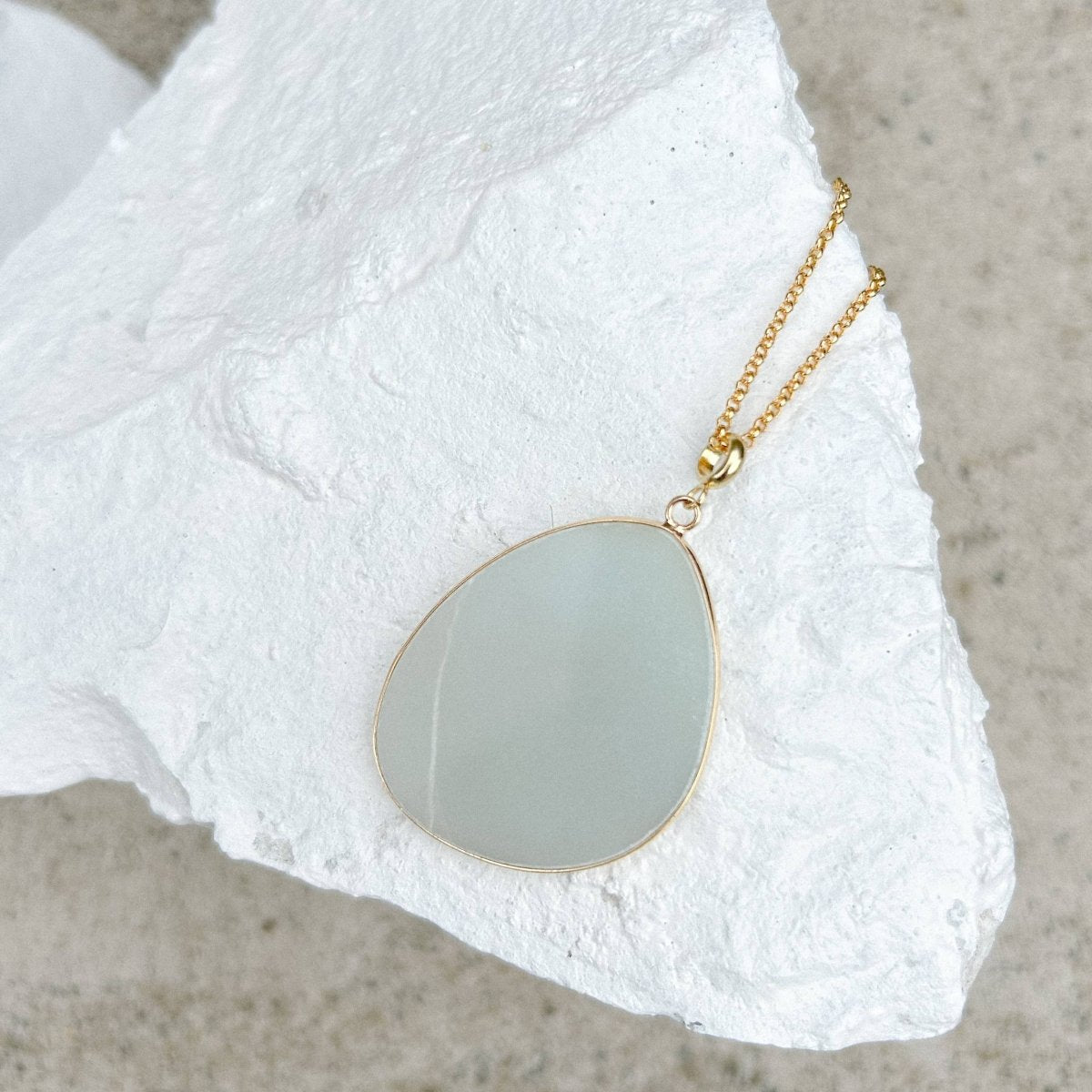 Amazonite Disc Necklace on a white stone surface. Sold by Helen Round