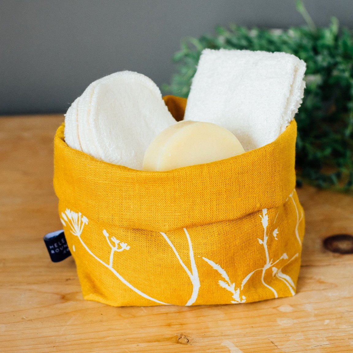 Linen storage bucket with bathroom essentials